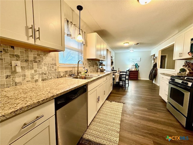 kitchen featuring appliances with stainless steel finishes, dark hardwood / wood-style floors, white cabinetry, and sink