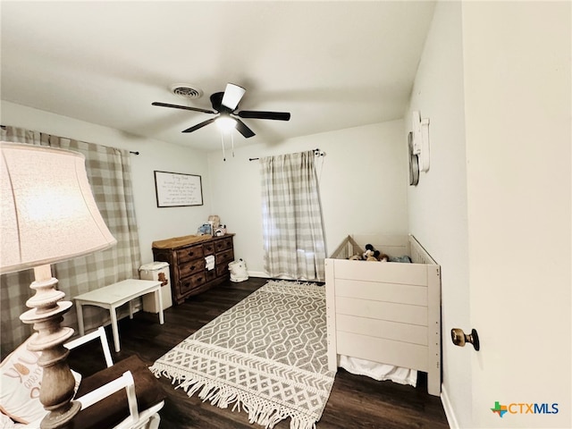 bedroom with ceiling fan and dark wood-type flooring