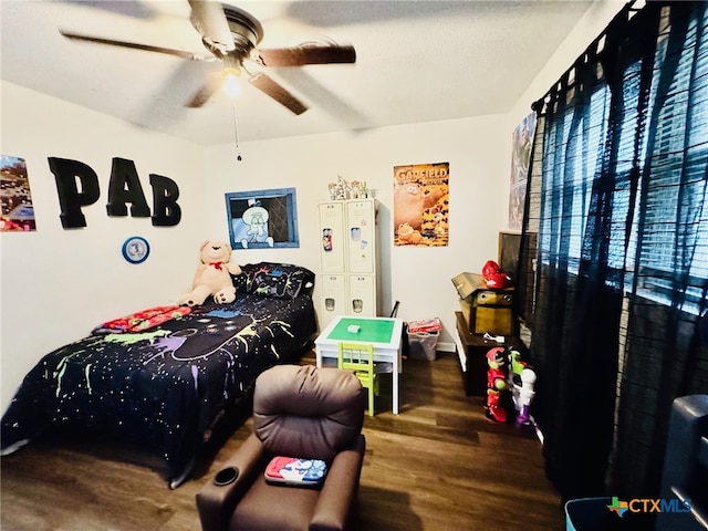 bedroom featuring dark hardwood / wood-style flooring and ceiling fan