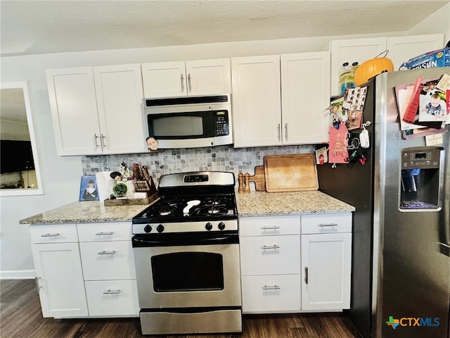 kitchen featuring dark hardwood / wood-style flooring, white cabinets, and stainless steel appliances