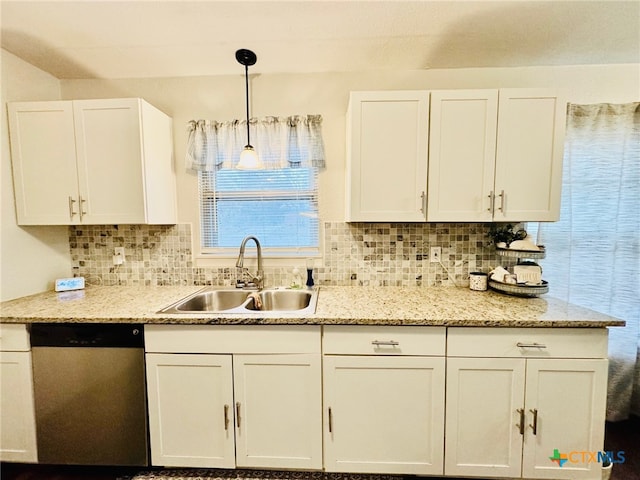 kitchen with sink, hanging light fixtures, stainless steel dishwasher, tasteful backsplash, and white cabinetry