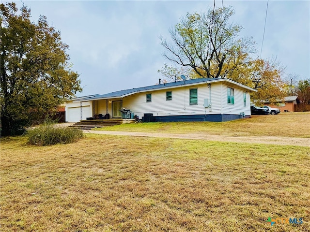 view of front of home with a garage and a front lawn