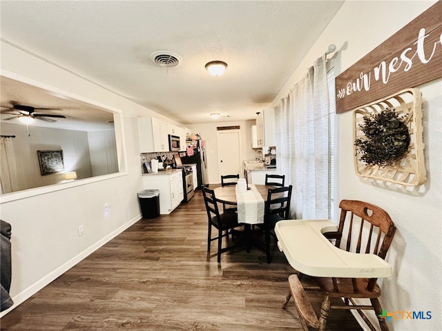 dining space featuring ceiling fan, dark hardwood / wood-style floors, and a textured ceiling