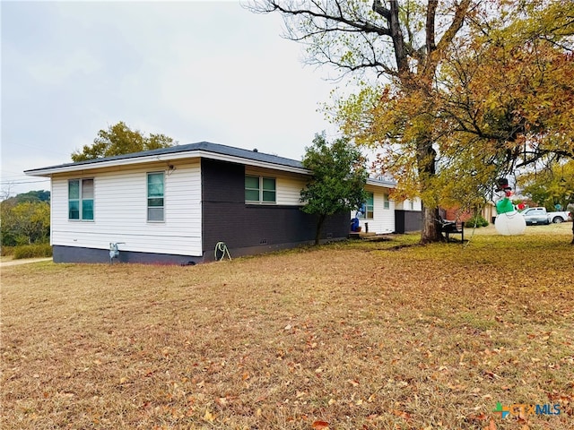 view of property exterior featuring a lawn