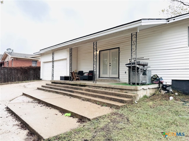 exterior space featuring a garage and covered porch