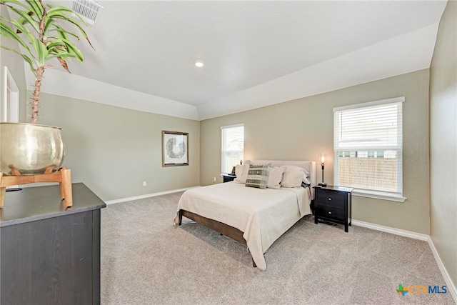 carpeted bedroom featuring multiple windows