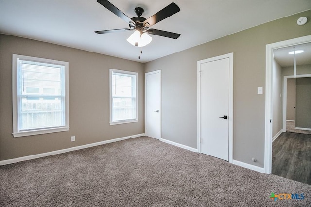 unfurnished bedroom featuring ceiling fan, baseboards, and carpet flooring