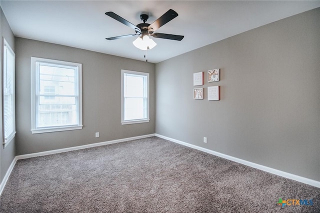 unfurnished room with carpet floors, ceiling fan, and baseboards