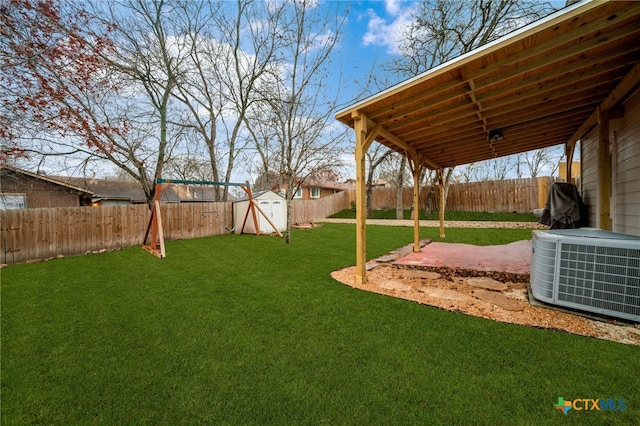 view of yard with a storage shed, central AC, and a patio