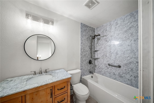 full bathroom with vanity, tiled shower / bath combo, and toilet