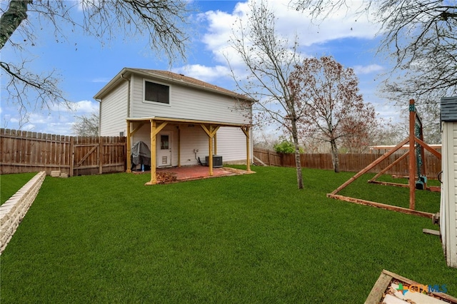 back of house featuring a lawn, a patio, and central air condition unit