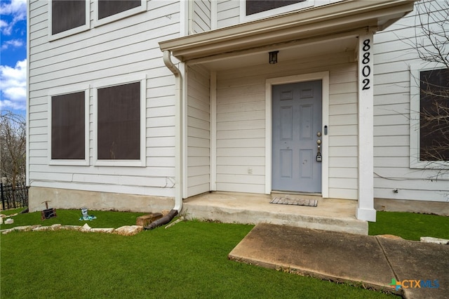 doorway to property featuring a yard