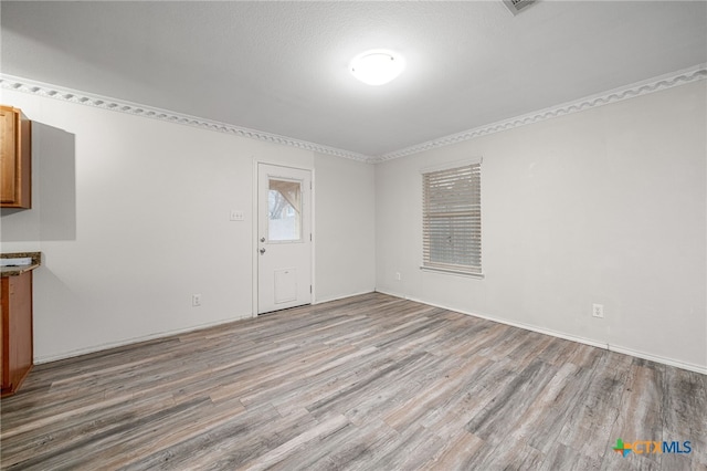 interior space featuring a textured ceiling and light hardwood / wood-style flooring