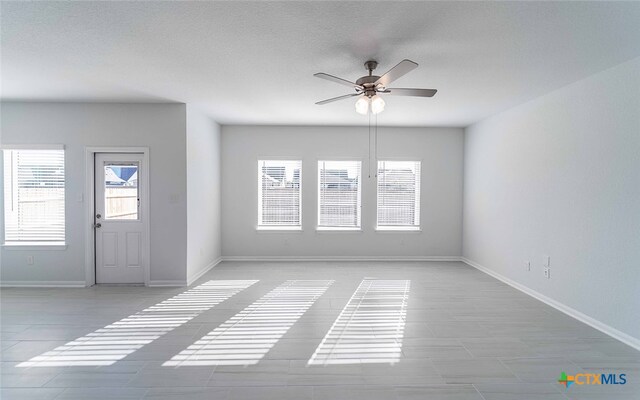 unfurnished room featuring a textured ceiling and ceiling fan