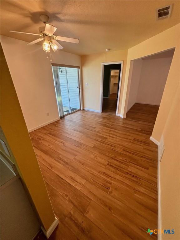 4306 Menard Dr, Killeen, TX 76549 - empty room featuring wood finished floors, ceiling fan, and baseboards