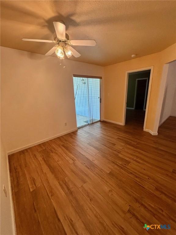 4306 Menard Dr, Killeen, TX 76549 - spare room with wood finished floors, baseboards, and a ceiling fan