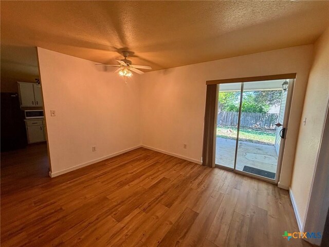 4306 Menard Dr, Killeen, TX 76549 - empty room with wood finished floors, ceiling fan, baseboards, and a textured ceiling