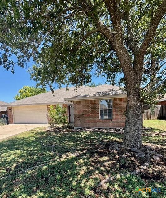 4306 Menard Dr, Killeen, TX 76549 - single story home with brick siding, an attached garage, and concrete driveway