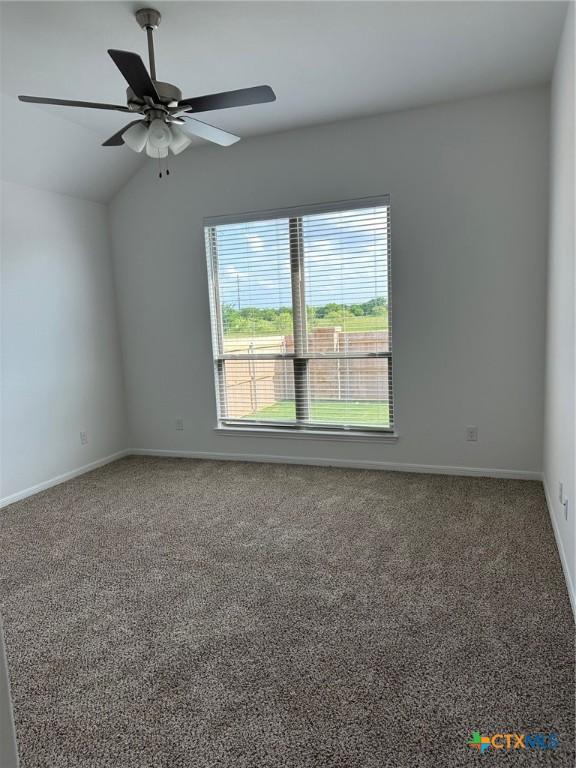7213 Touchstone Dr, Temple, TX 76502 - carpeted empty room featuring vaulted ceiling, a ceiling fan, and baseboards