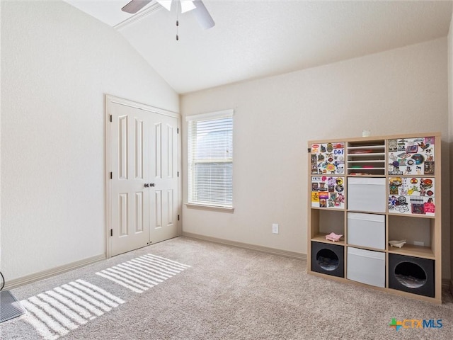 interior space with ceiling fan, lofted ceiling, a closet, and carpet floors