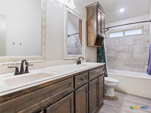 full bathroom featuring toilet, hardwood / wood-style flooring, vanity, and shower / tub combo with curtain