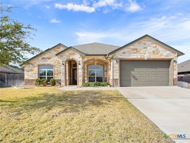 ranch-style home featuring a front lawn and a garage