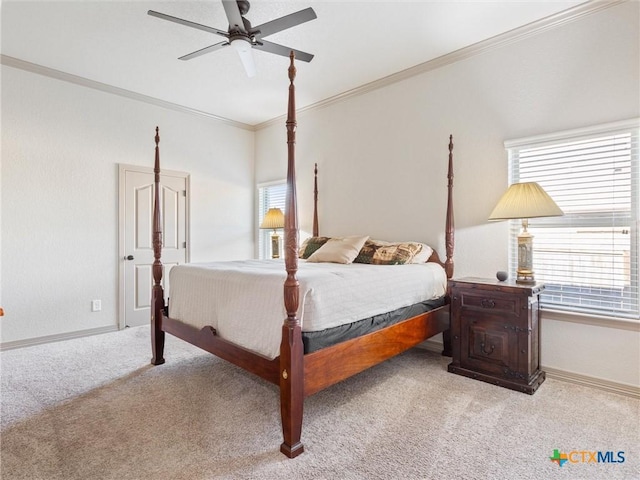 carpeted bedroom featuring ceiling fan and crown molding