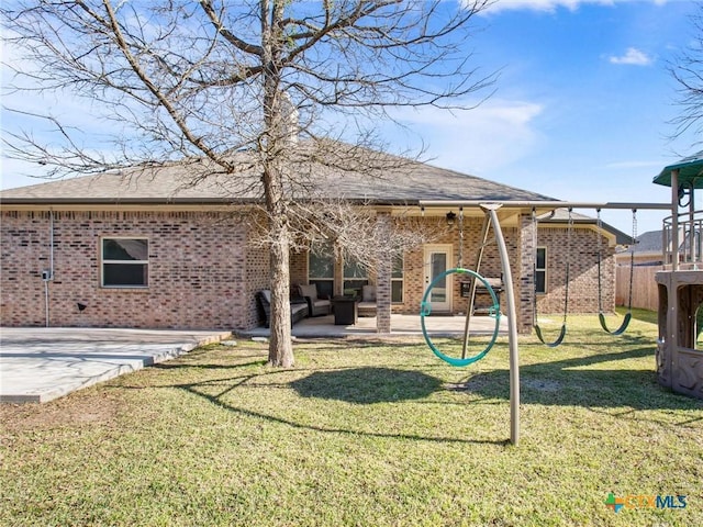 back of property featuring a lawn, a patio, and a playground