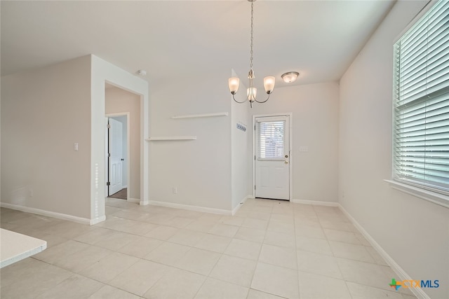 foyer entrance with a chandelier and light tile patterned floors