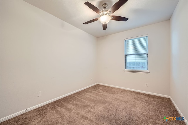 spare room featuring carpet and ceiling fan