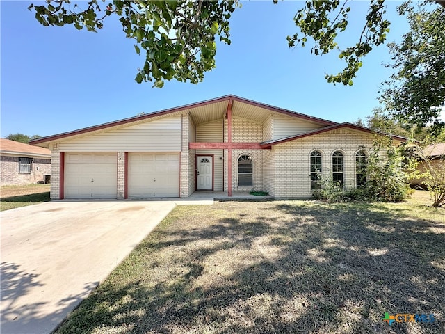 view of front of house featuring a garage and a front lawn