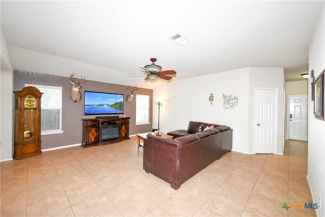 tiled living room with ceiling fan