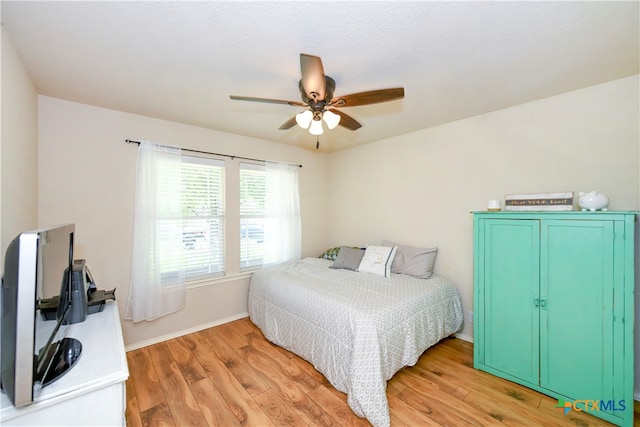 bedroom featuring light wood-type flooring and ceiling fan