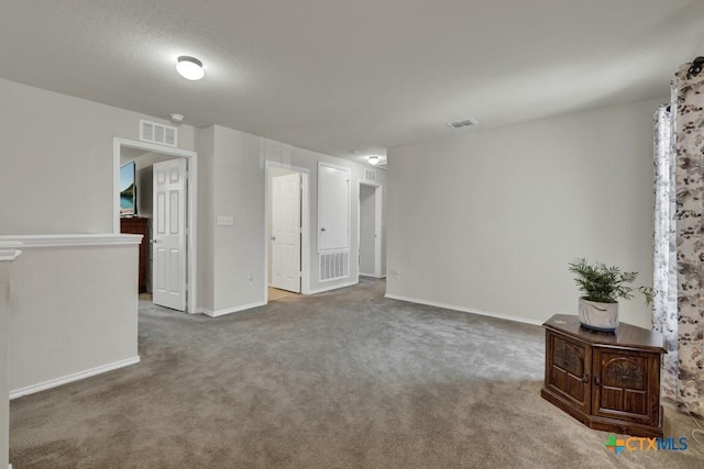 carpeted spare room with baseboards
