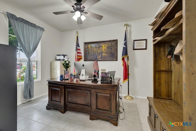 office featuring ceiling fan, light tile patterned floors, and baseboards