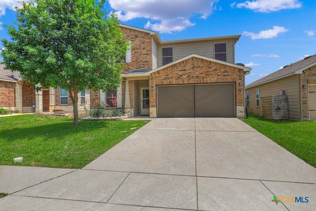 view of front of home featuring a front yard, brick siding, and an attached garage