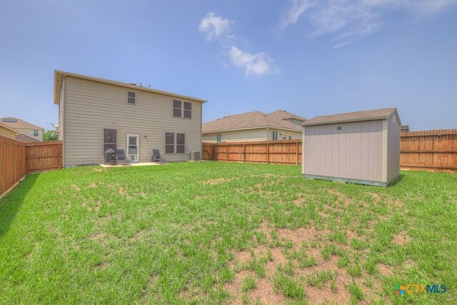 rear view of property with a storage unit, an outbuilding, and cooling unit