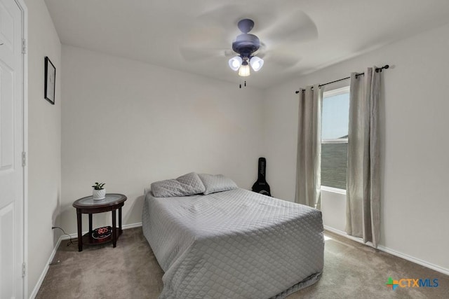 carpeted bedroom with baseboards and ceiling fan