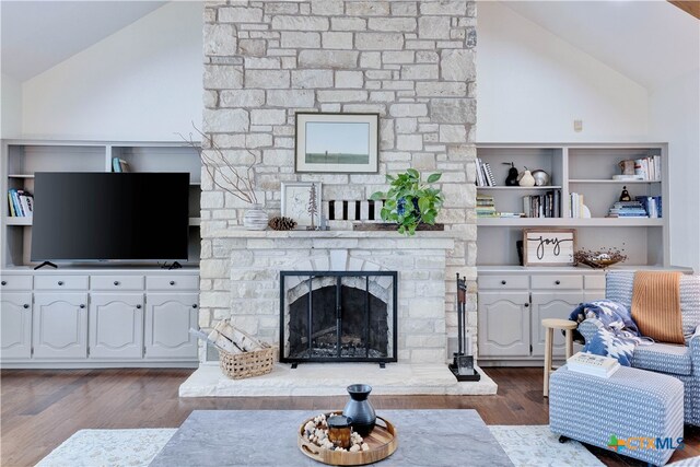 living room with a fireplace, light hardwood / wood-style floors, and lofted ceiling