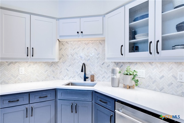 kitchen featuring dishwasher, white cabinetry, sink, and decorative backsplash