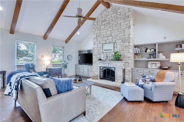 living room with dark wood-type flooring, beamed ceiling, and high vaulted ceiling