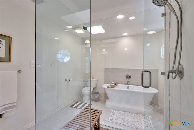 bathroom featuring tile patterned flooring, toilet, separate shower and tub, and a skylight