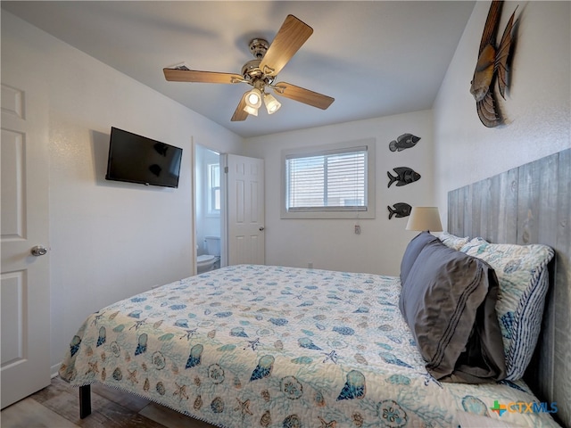 bedroom featuring ensuite bath, wood-type flooring, and ceiling fan