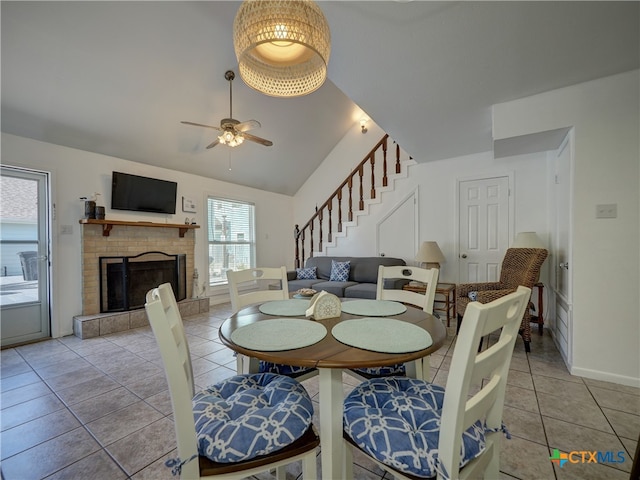 tiled dining room featuring high vaulted ceiling and ceiling fan