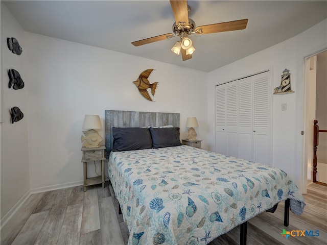 bedroom featuring light hardwood / wood-style flooring, ceiling fan, and a closet