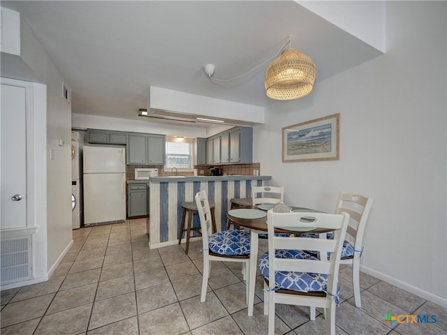 dining space featuring light tile patterned floors