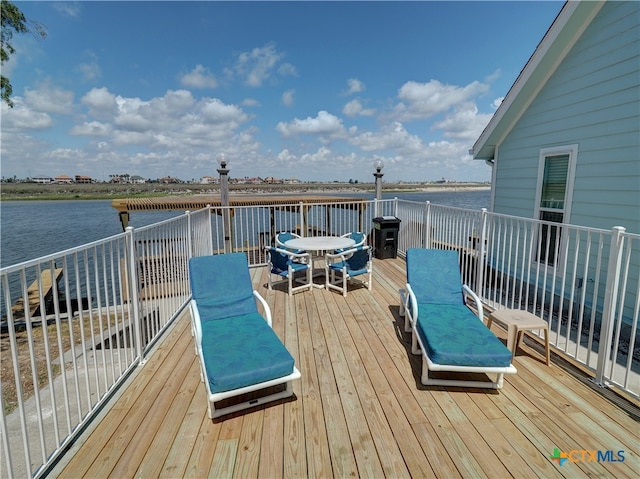 deck with a water view and grilling area