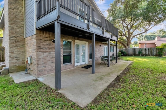 608 Chimney Rock Dr, Victoria, TX 77904 - back of property featuring french doors, a balcony, brick siding, and a patio area