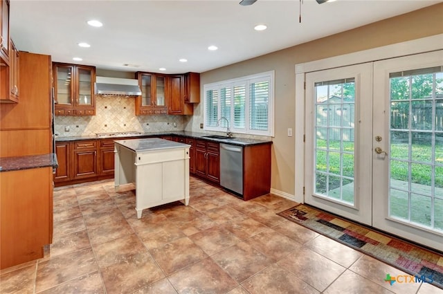 608 Chimney Rock Dr, Victoria, TX 77904 - kitchen featuring appliances with stainless steel finishes, a sink, brown cabinetry, french doors, and backsplash