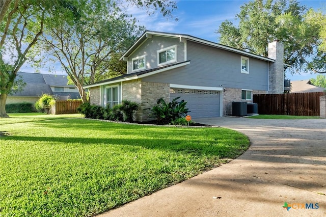 608 Chimney Rock Dr, Victoria, TX 77904 - view of side of home with an attached garage, concrete driveway, a chimney, brick siding, and cooling unit